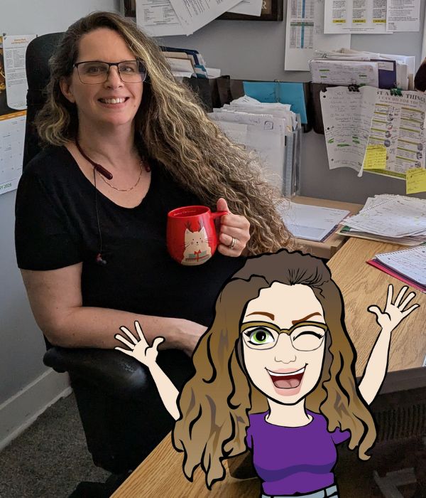 Sherri sitting at her not so tidy desk and Mini Sherri upfront doing what she does best — not working