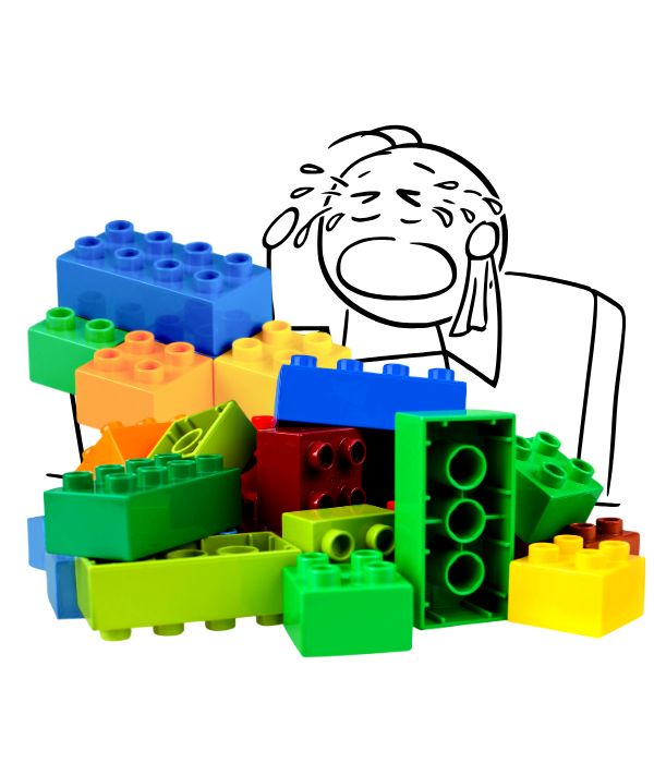 cartoon person crying with a large stack of Lego blocks in front of them